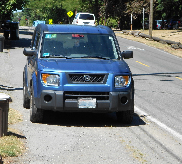 Photo of car illegally parked on sidewalk