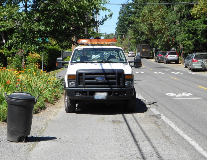 Photo of car illegally parked on sidewalk