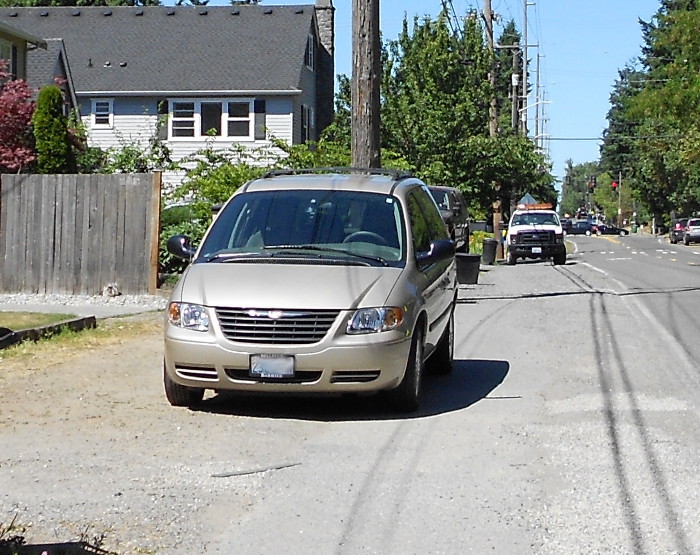 Photo of car illegally parked on sidewalk