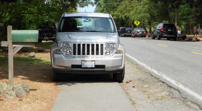 Photo of car illegally parked on sidewalk