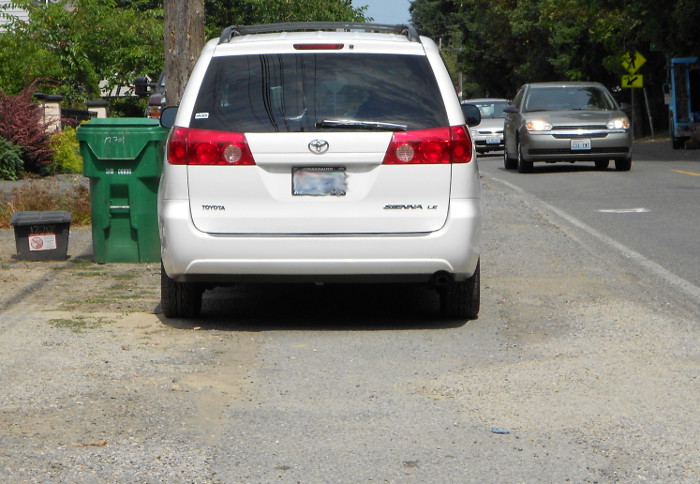 Photo of car illegally parked on sidewalk