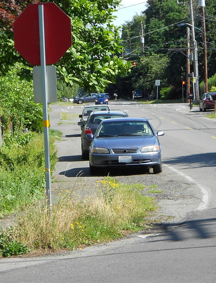 Photo of cars illegally parked on sidewalk