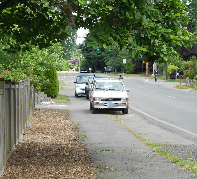 Photo of cars illegally parked on sidewalk