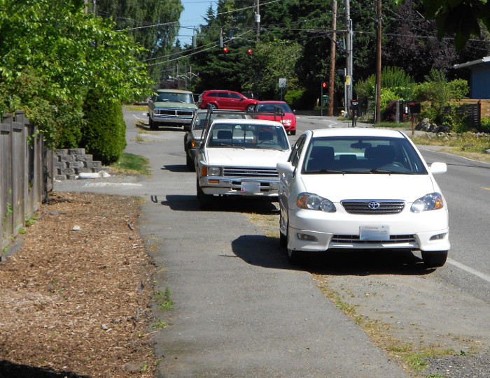 Photo of cars illegally parked on sidewalk