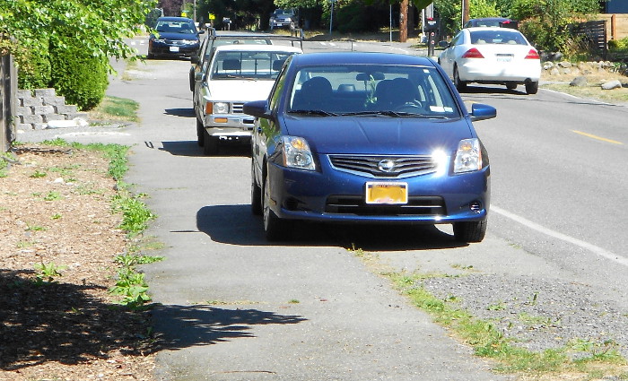 Photo of cars illegally parked on sidewalk